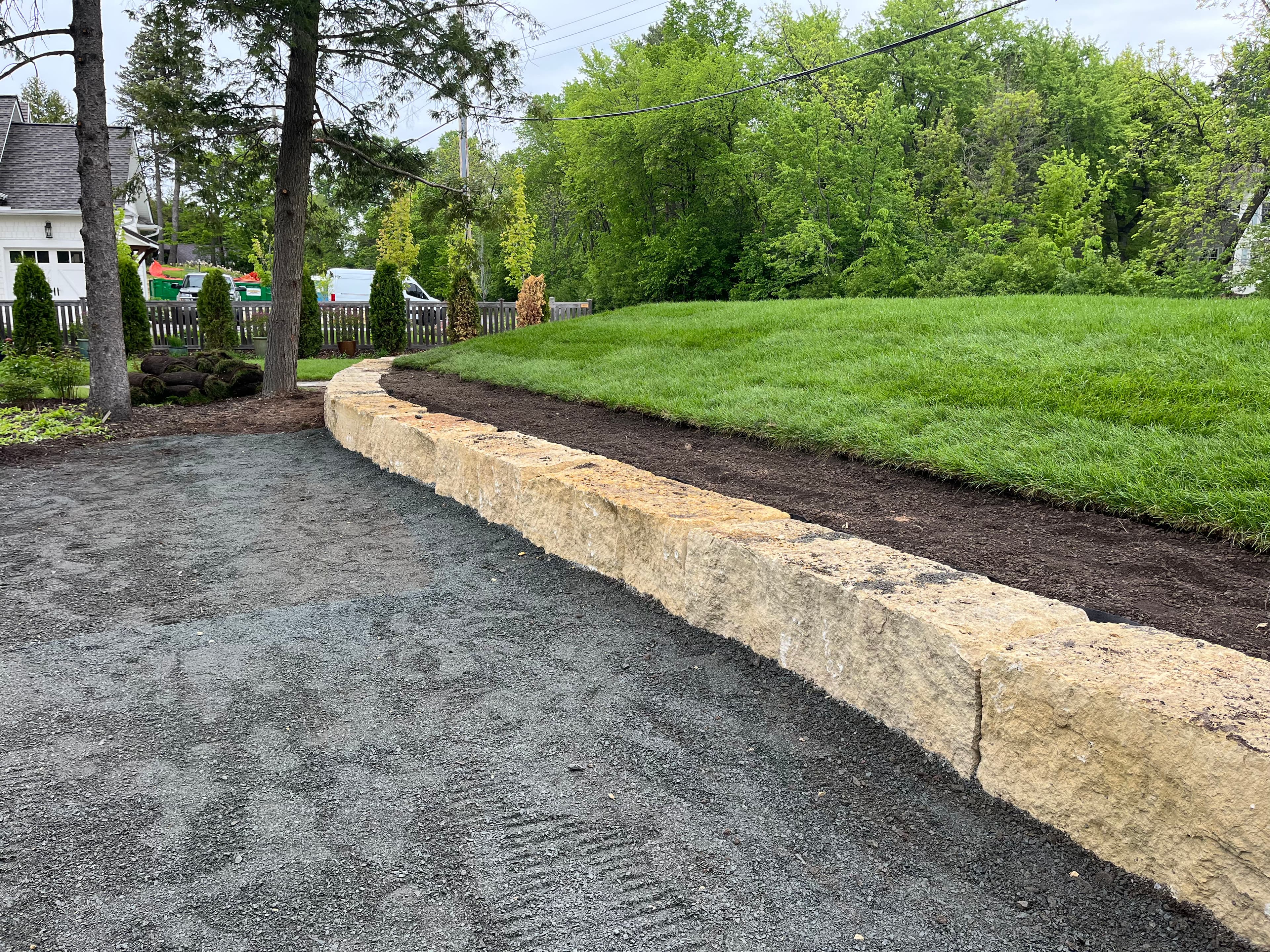 Project Limestone Boulder Retaining Wall Frames a Septic Mound in Dellwood image