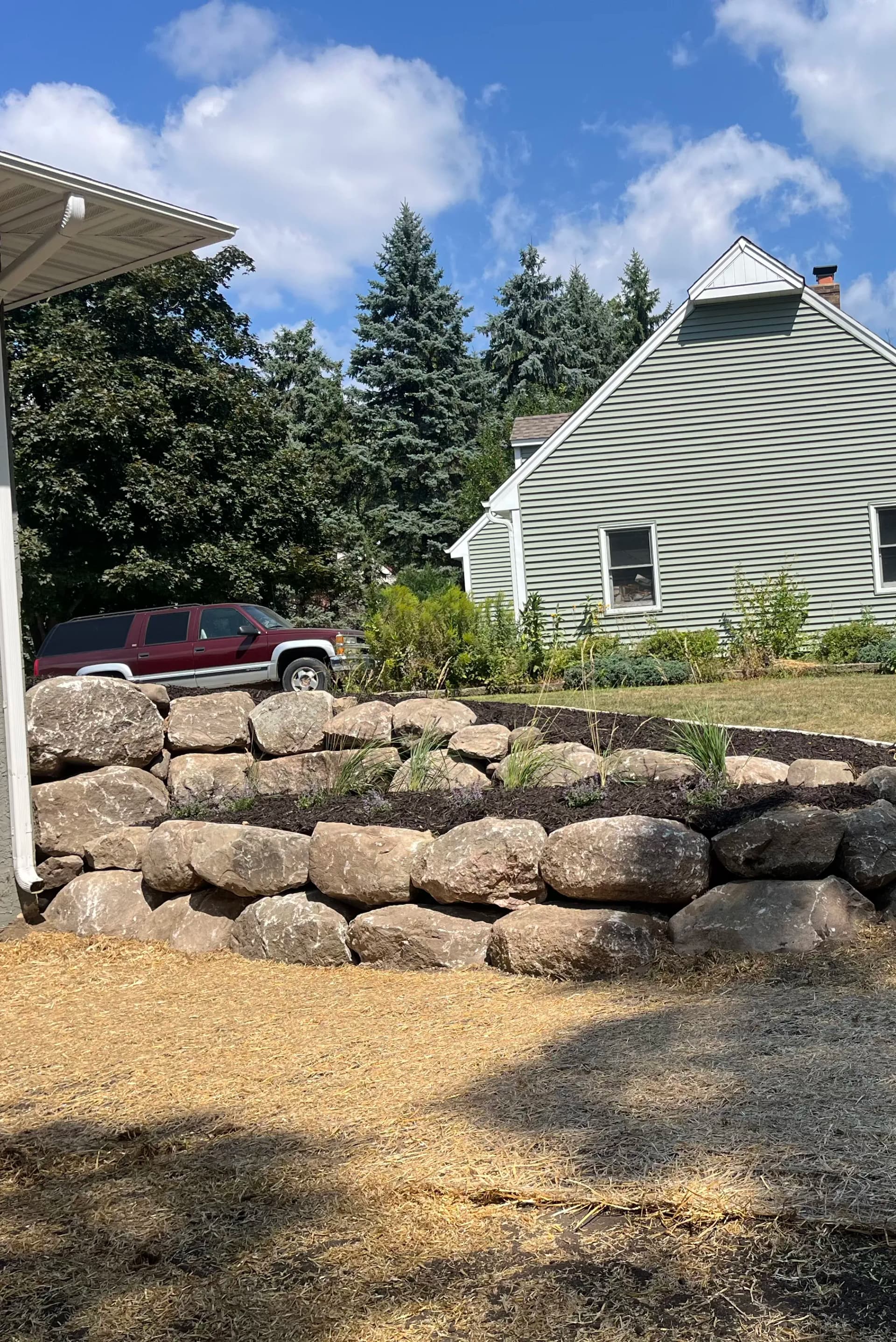 Tiered Boulder Walls and Privacy Berm Done Right in New Brighton image